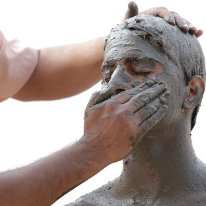 Mud therapy session for natural detoxification and holistic healing at a wellness center